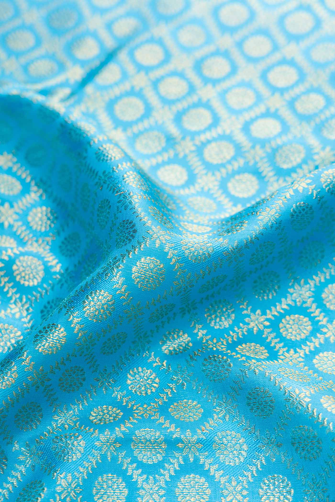 Close up of Pure Silk Pure Zari Sky Blue Dual Tone Kanchipuram Saree with Zari Brocade on the body and Fancy Border displaying folds