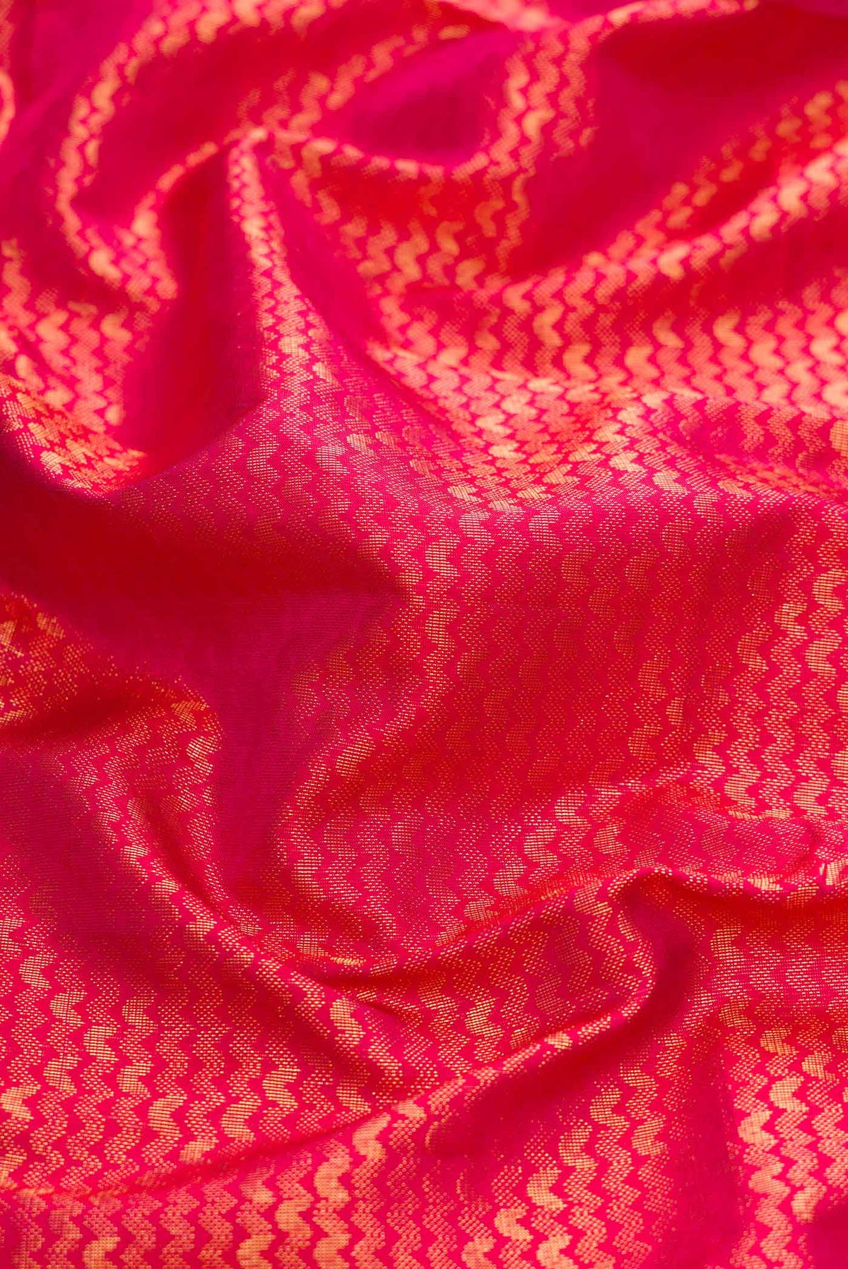 Close up of Red Dual Tone Soft Silk Saree with Zari Brocade on the body and Zari Border displaying folds