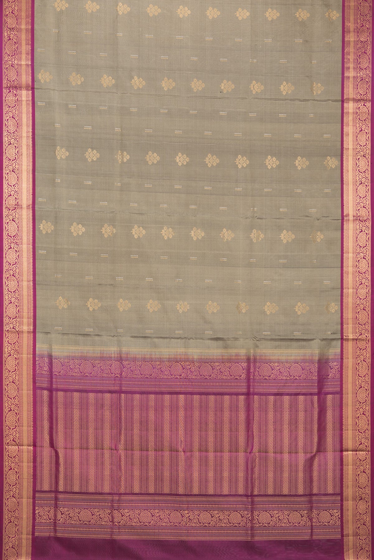 Flat view of Pure Silk Grey Soft Saree with Zari Butta on the body and Zari Border. 