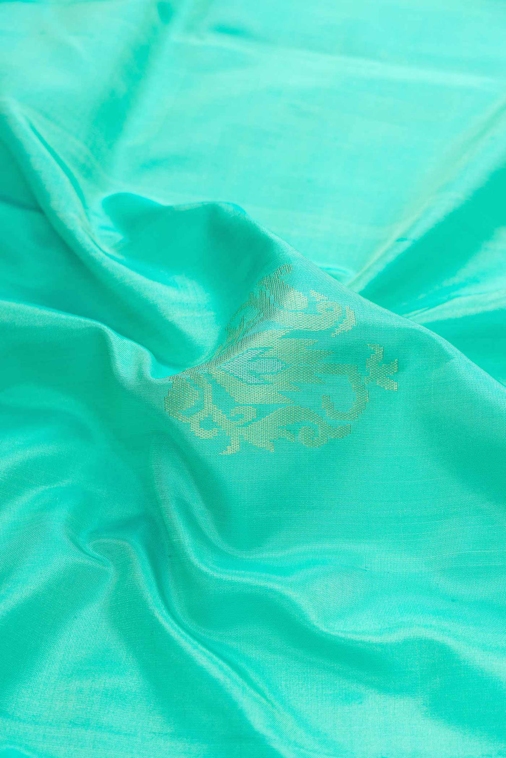 Close up of Sea Green Dual Tone Soft Silk Saree with Zari Butta on the body and Zari Border displaying folds