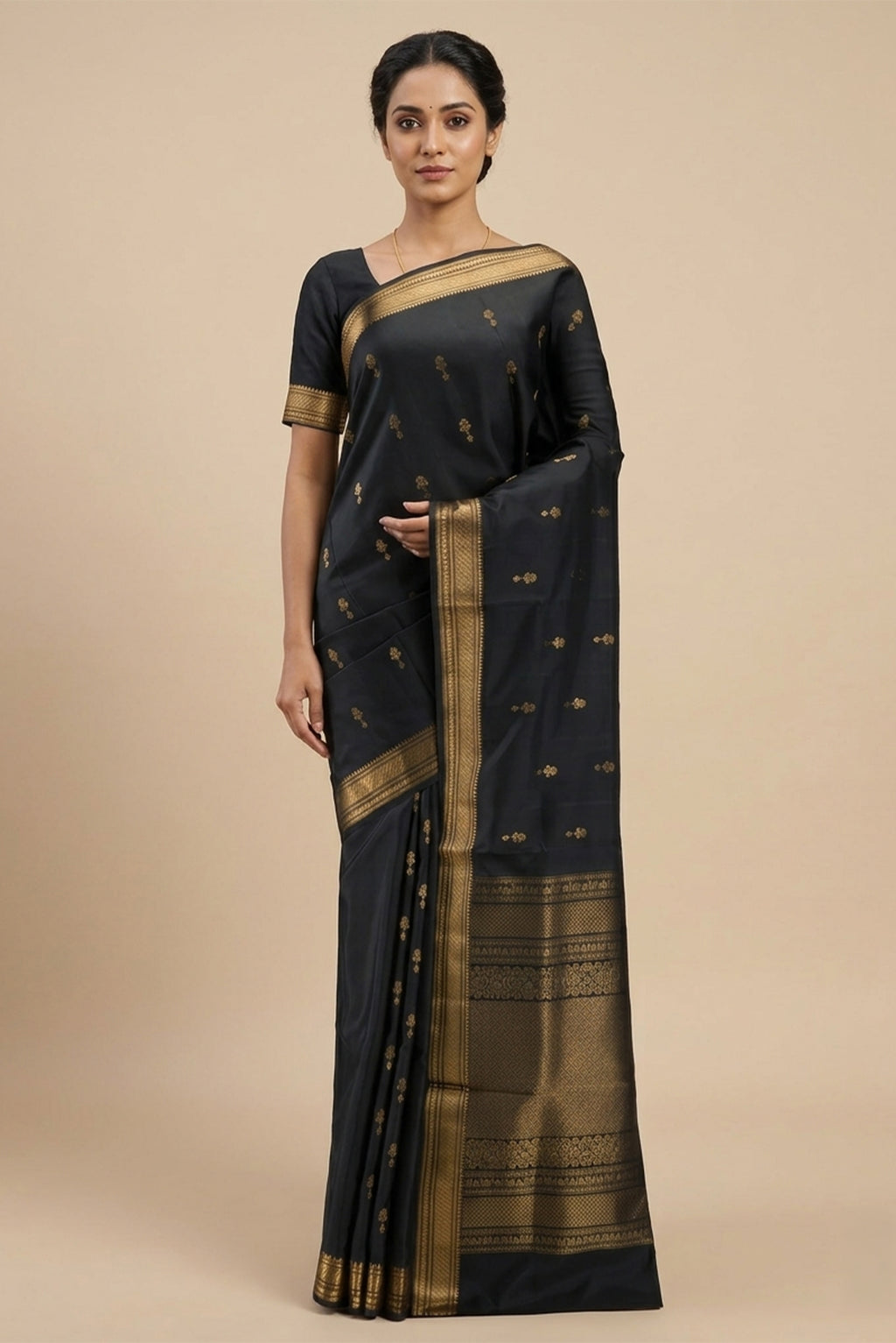 Model wearing a Black Soft Silk Saree with Zari Butta on the body and Zari Border.