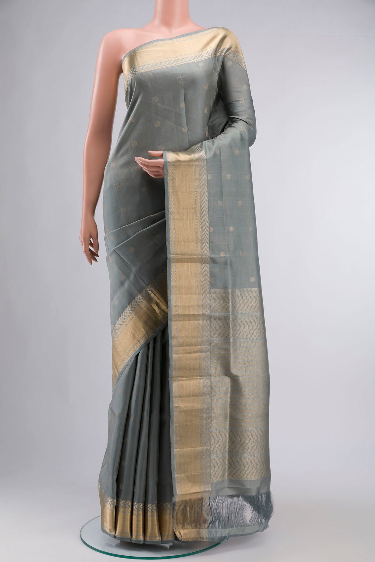 Grey Soft Silk Saree with Zari Butta on the body and Zari Border displayed on a mannequin