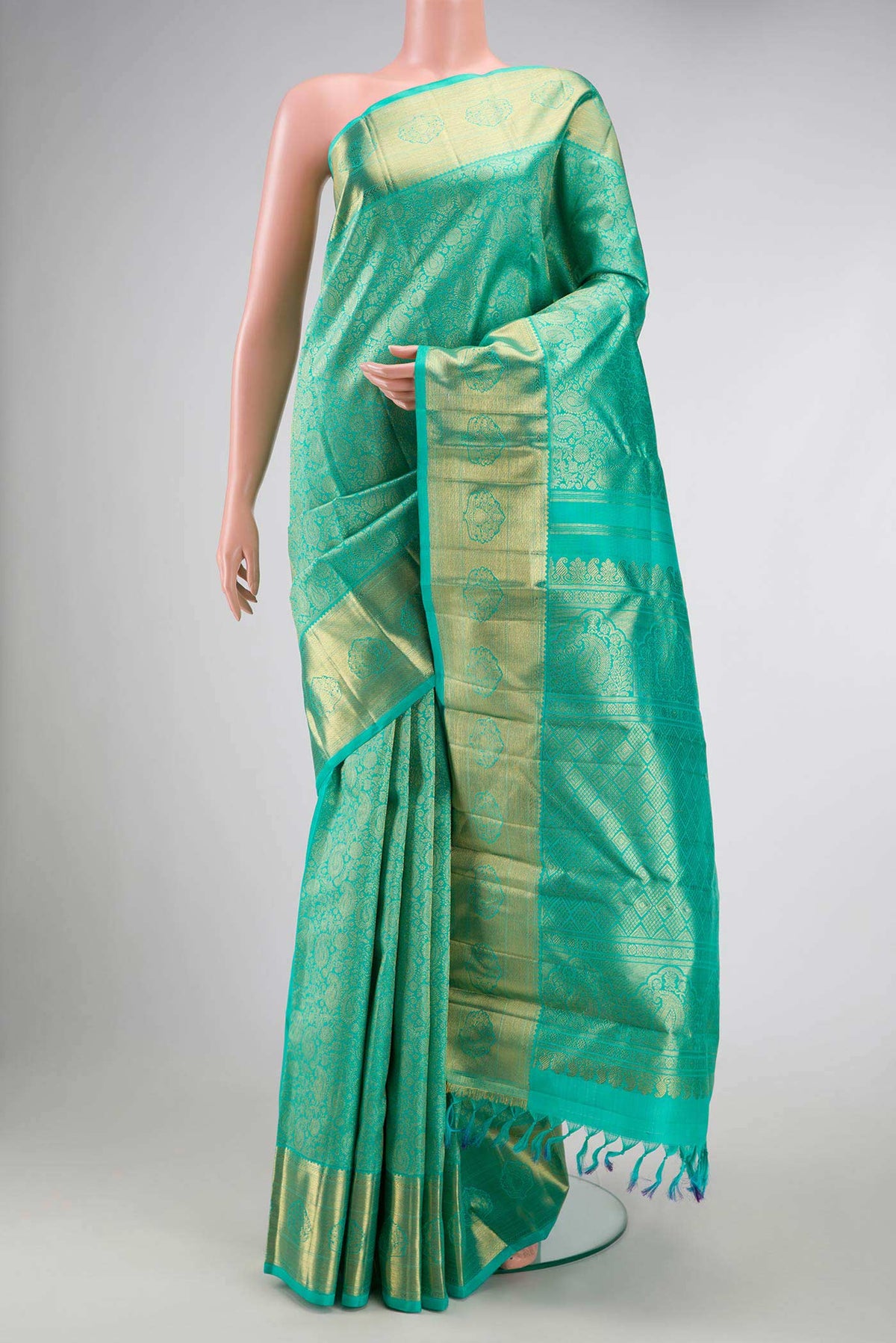 Pure Silk Pure Zari Sea Green Dual Tone Kanchipuram Saree with Zari Brocade on the body and Zari Border displayed on a mannequin