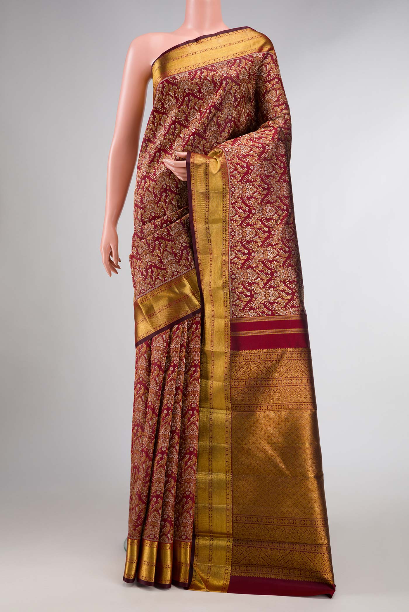 Maroon Dual Tone Kanchipuram Silk Saree with Zari Brocade on the body and Zari Border displayed on a mannequin