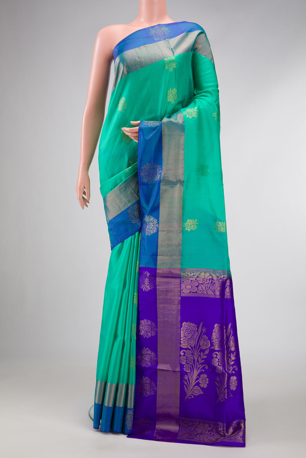 Sea Green Dual Tone Soft Silk Saree with Zari Butta on the body and Fancy Border.  displayed on a mannequin