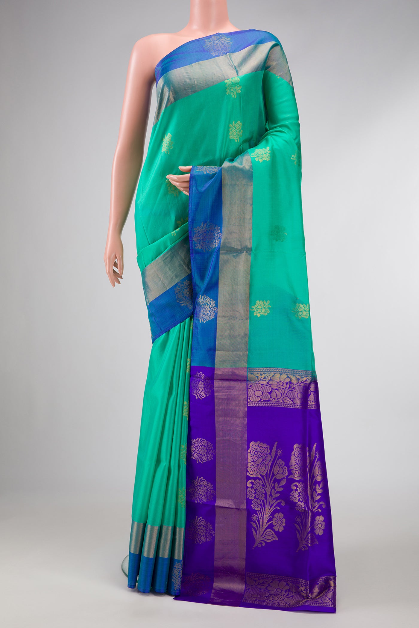 Sea Green Dual Tone Soft Silk Saree with Zari Butta on the body and Fancy Border.  displayed on a mannequin