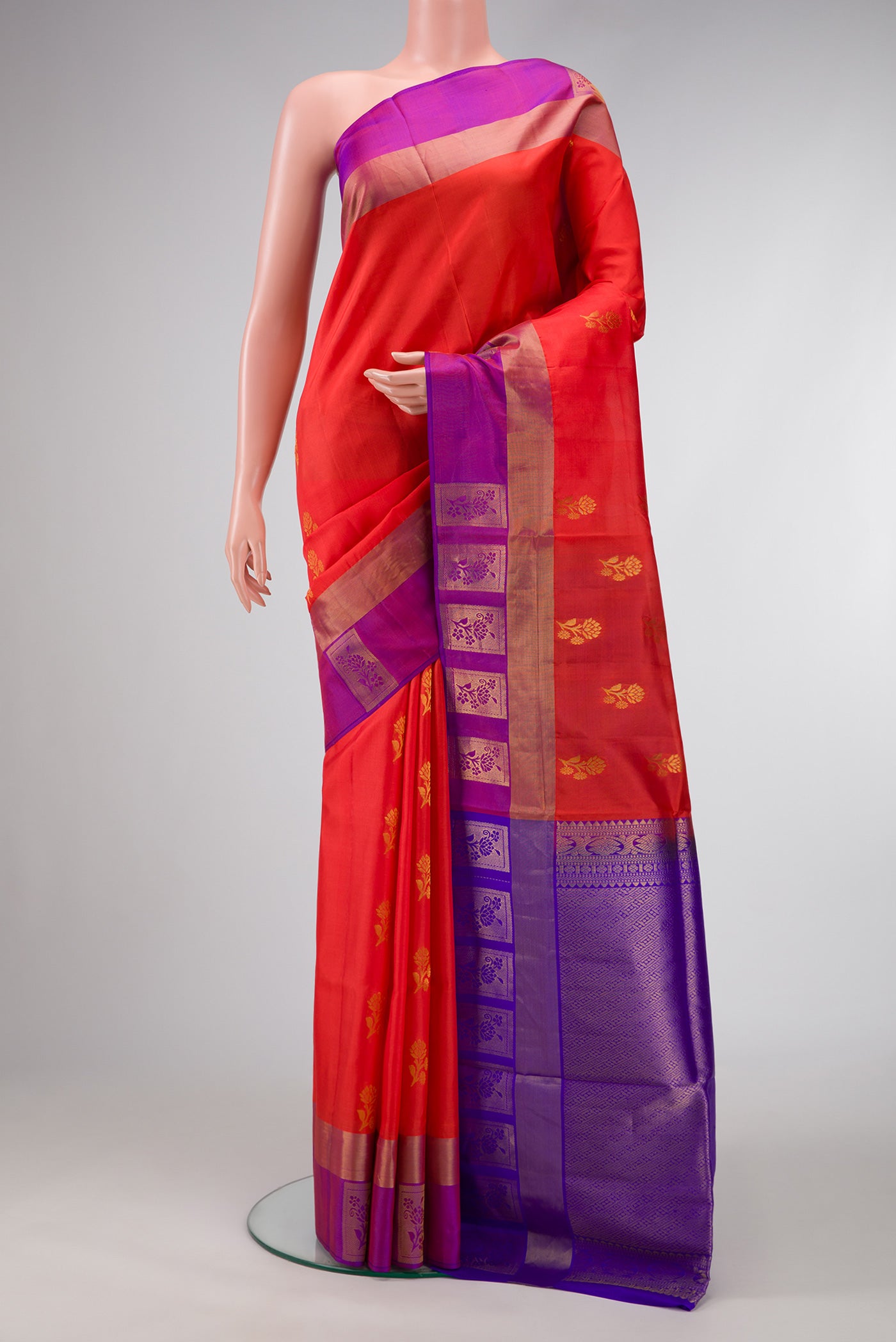 Orange Dual Tone Soft Silk Saree with Zari Butta on the body and Fancy Border.  displayed on a mannequin