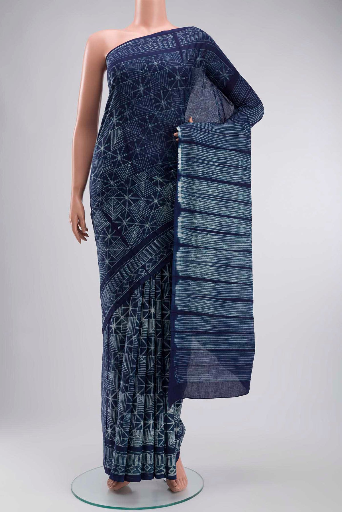 Navy Blue Cotton Saree with Printed design on the body and Printed Border displayed on a mannequin
