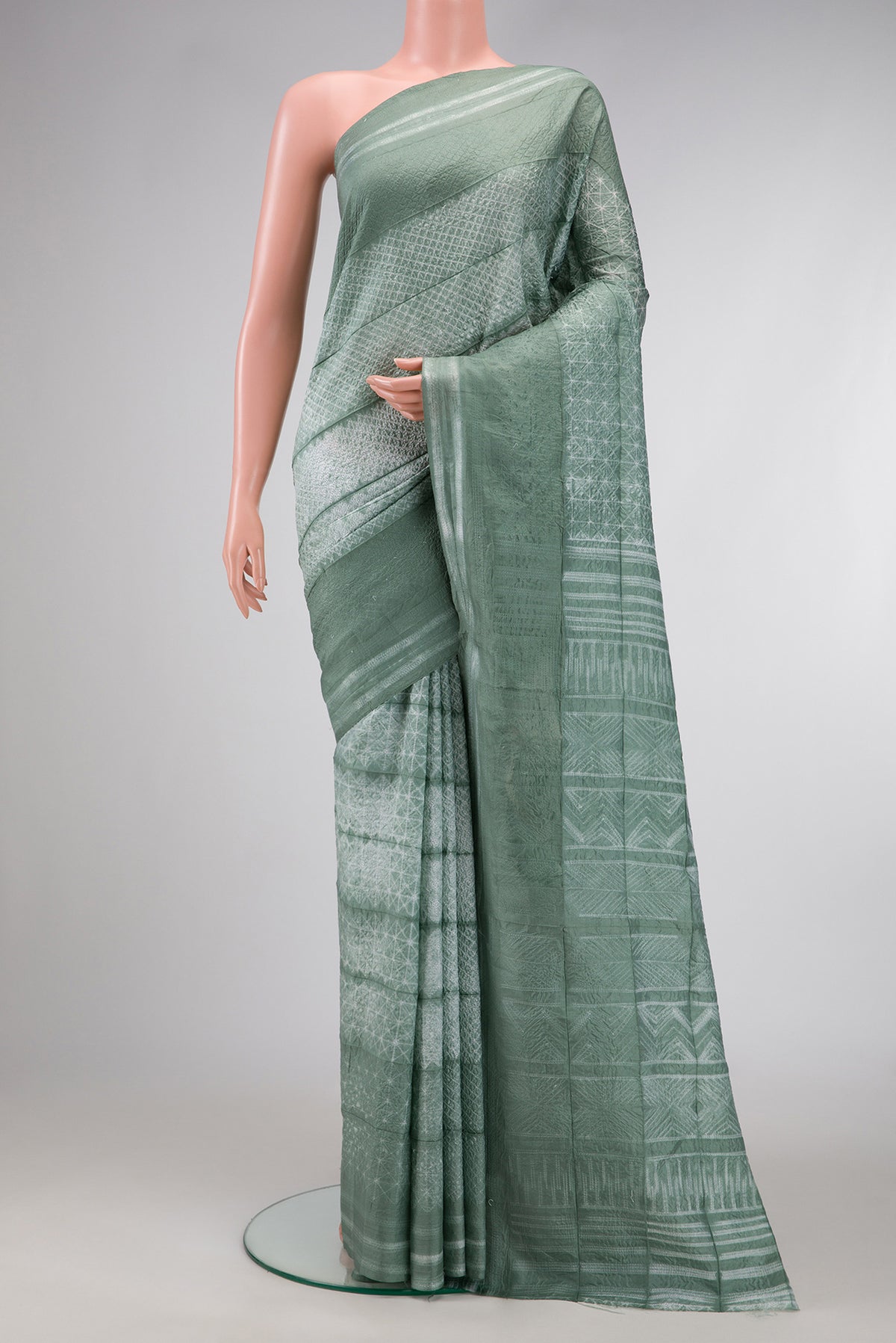 Light Green Dual Tone Tussar Silk Saree with Printed design on the body and Printed Border.  displayed on a mannequin
