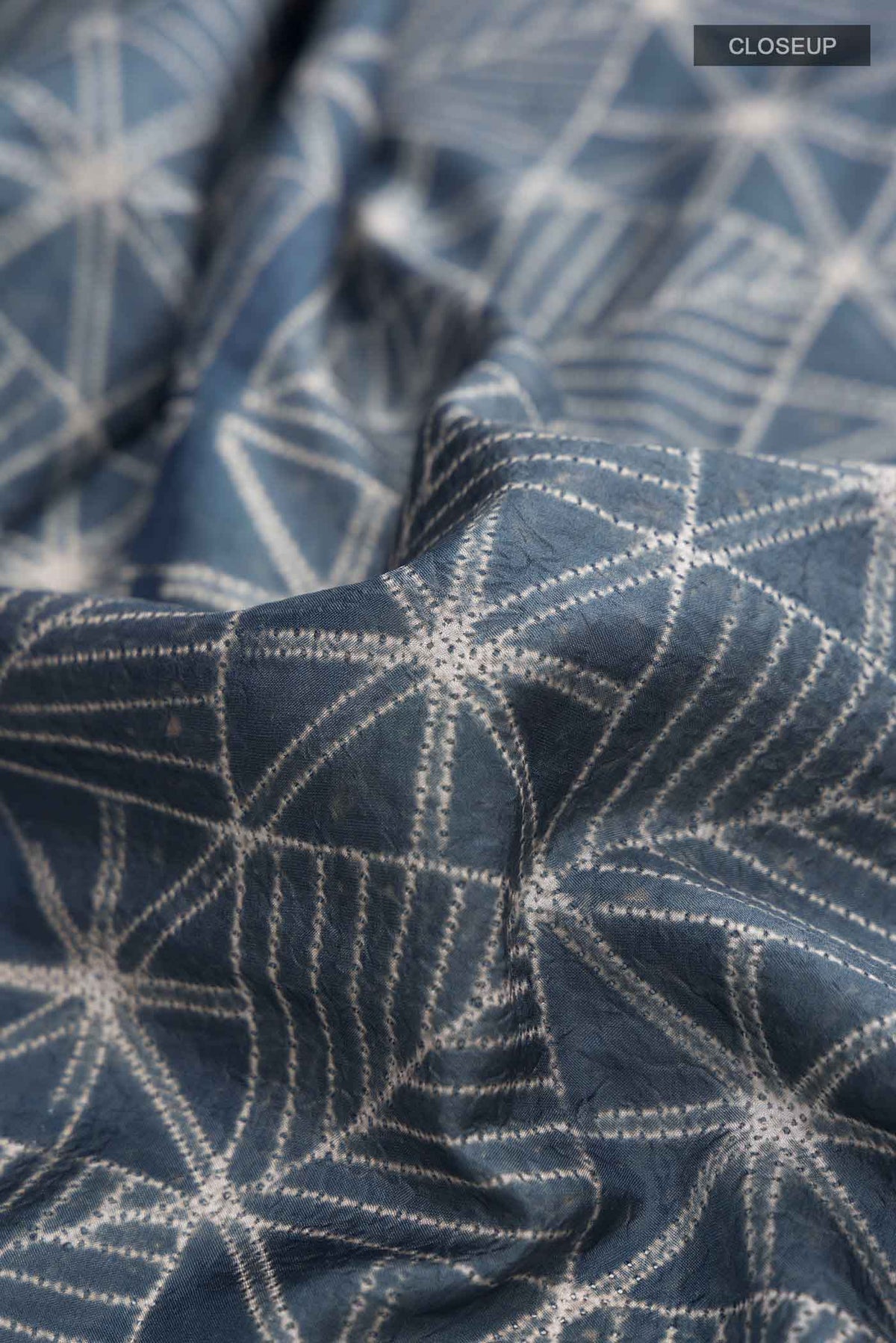 Close up of Blue Grey Printed Silk SareePrinted design on the body and Printed Border displaying folds