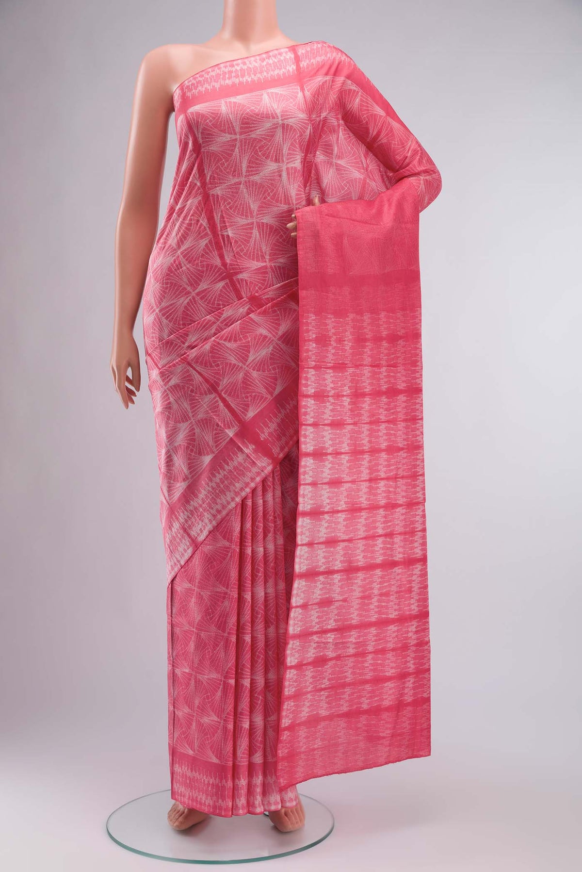 Coral Printed Silk SareePrinted design on the body and Printed Border displayed on a mannequin