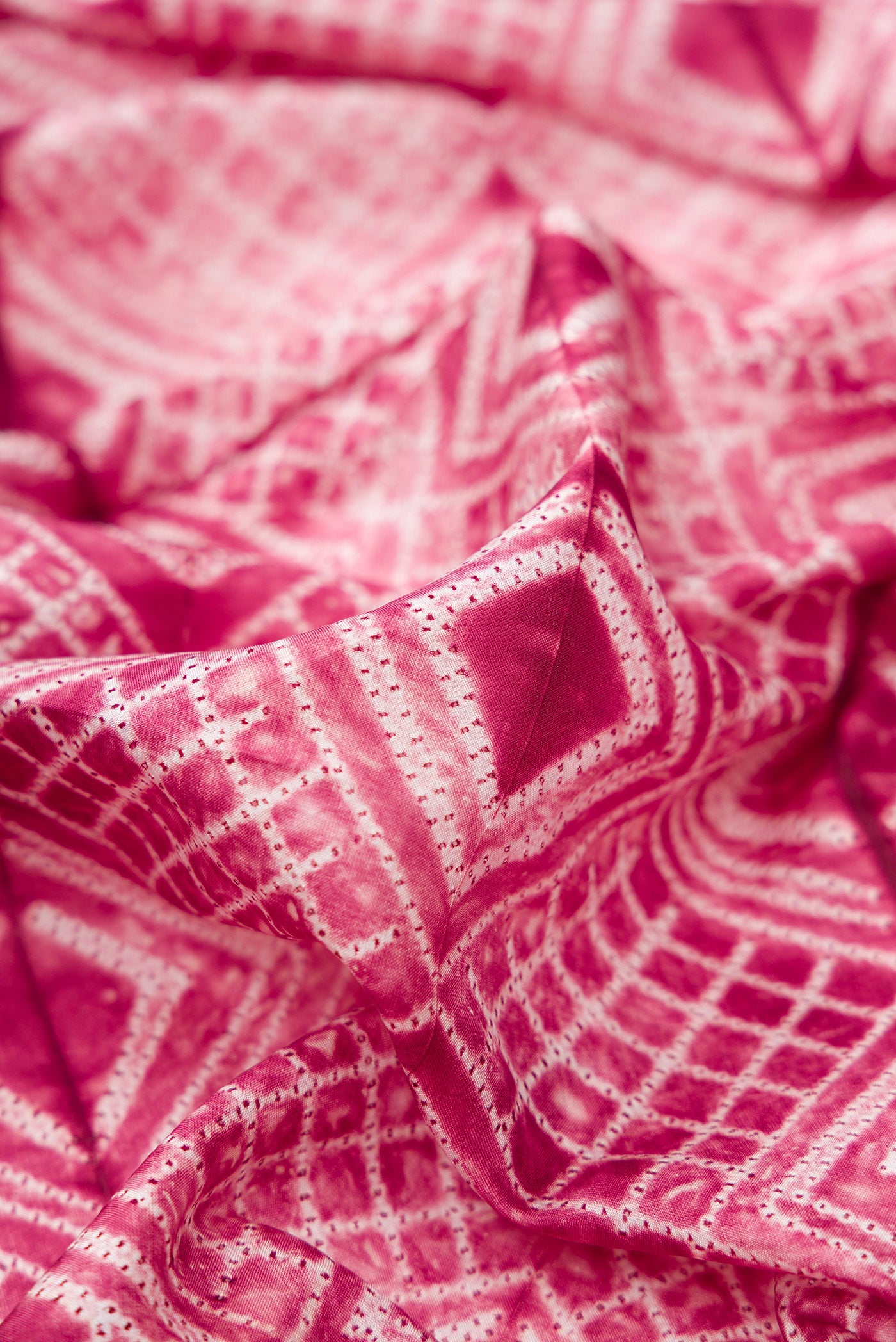 Close up of Maroon Dual Tone Tussar Silk Saree with Printed design on the body and Plain Border.  displaying folds
