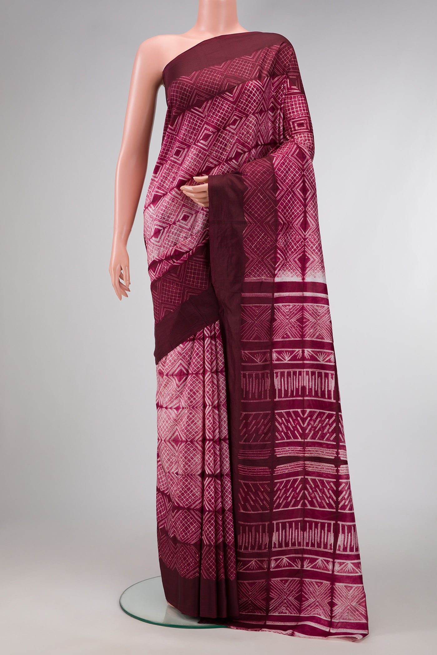 Maroon Dual Tone Tussar Silk Saree with Printed design on the body and Plain Border.  displayed on a mannequin