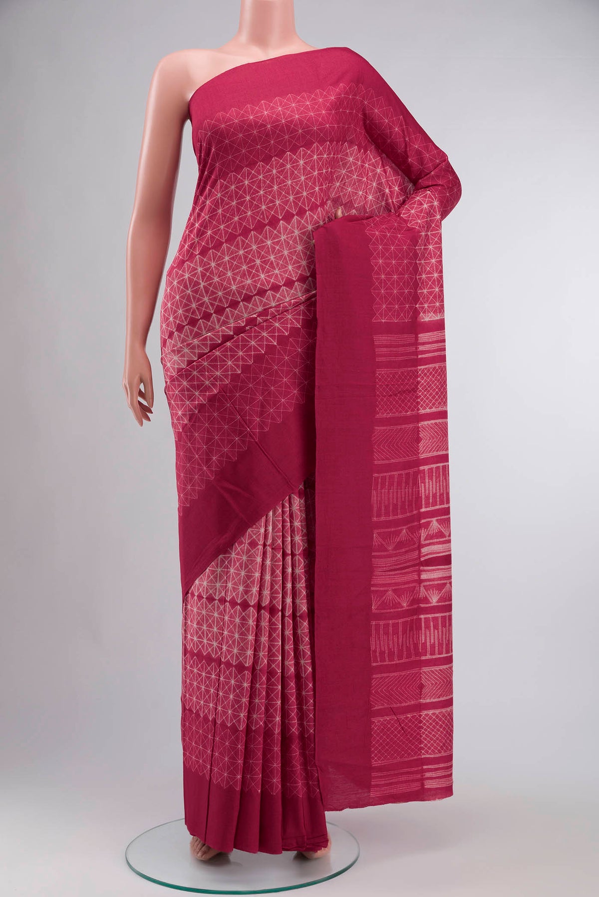 Red Tussar Silk Saree Printed design on the body and Plain Border displayed on a mannequin