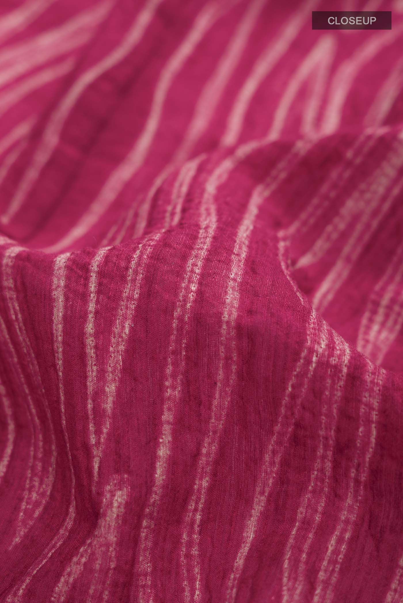 Close up of Maroon Tussar Silk Saree Printed design on the body and Without Border displaying folds
