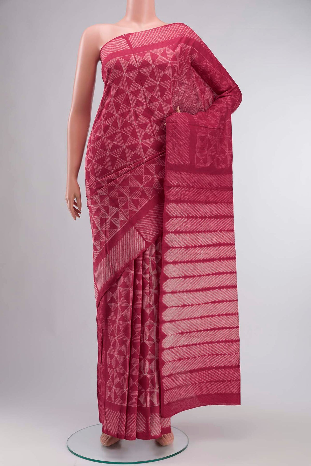 Red Tussar Silk Saree Printed design on the body and Plain Border displayed on a mannequin
