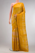 Mustard Dual Tone Tussar Silk Saree with Printed design on the body and Without Border.  displayed on a mannequin