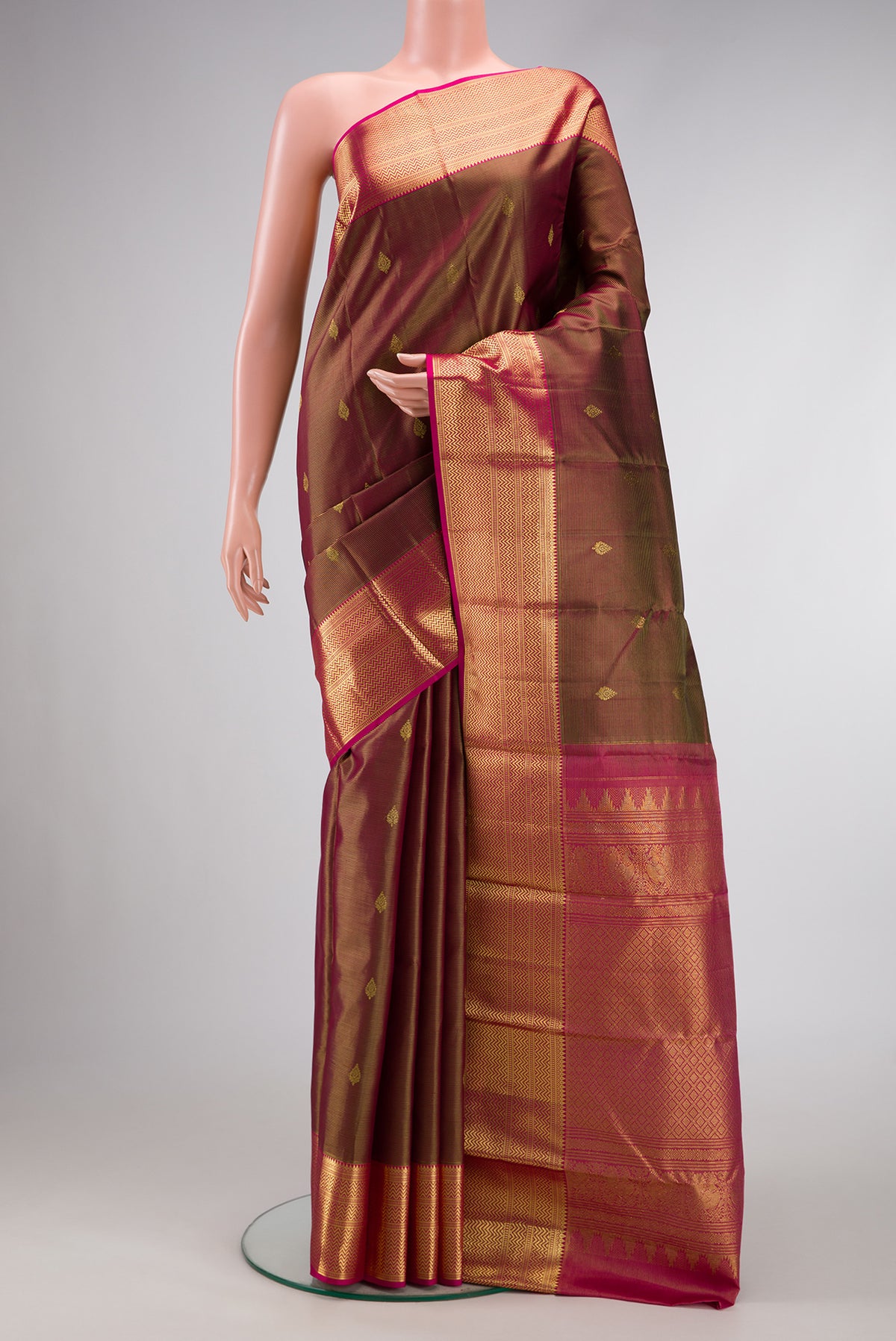 Maroon Dual Tone Kanchipuram Silk Saree with Zari Butta on the body and Zari Border.  displayed on a mannequin