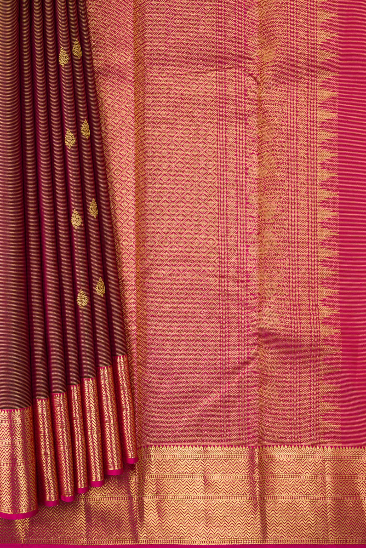 Pleats and pallu of Maroon Dual Tone Kanchipuram Silk Saree with Zari Butta on the body and Zari Border. 