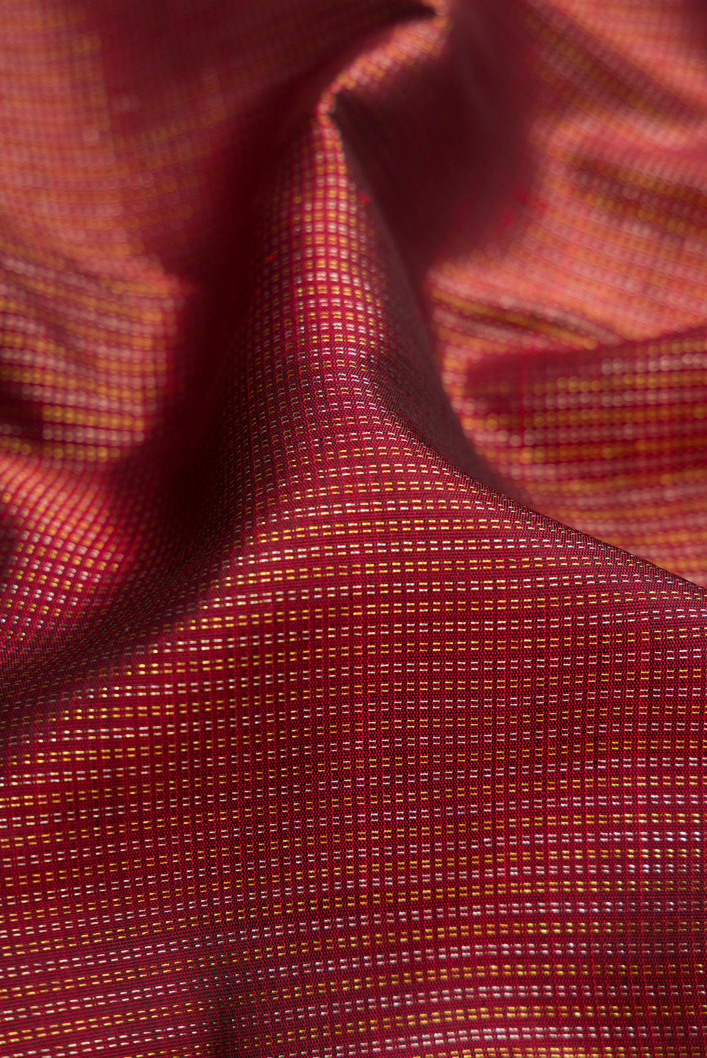 Close up of Maroon Dual Tone Kanchipuram Silk Saree with Stripes on the body and Zari Border.  displaying folds