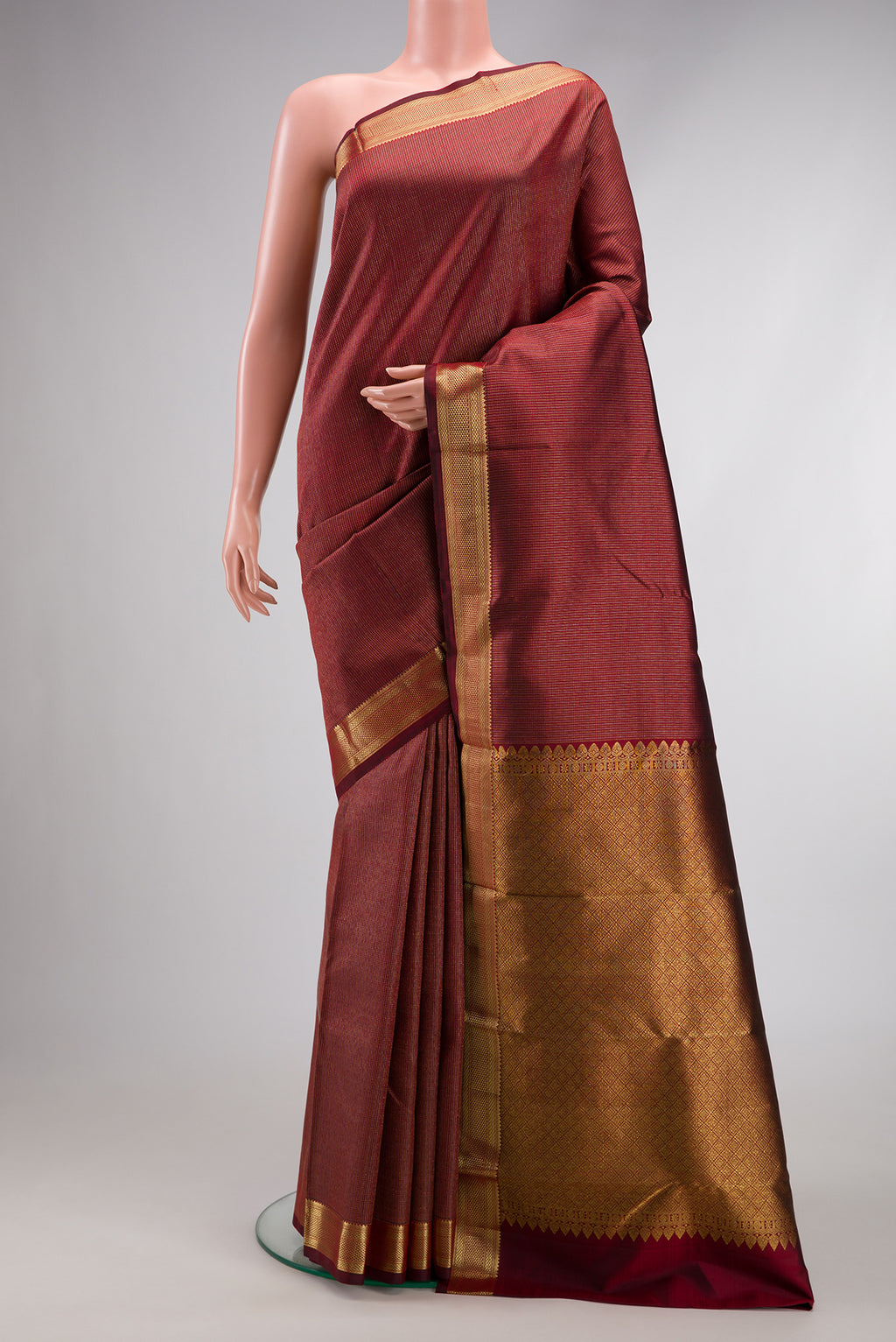 Maroon Dual Tone Kanchipuram Silk Saree with Stripes on the body and Zari Border.  displayed on a mannequin