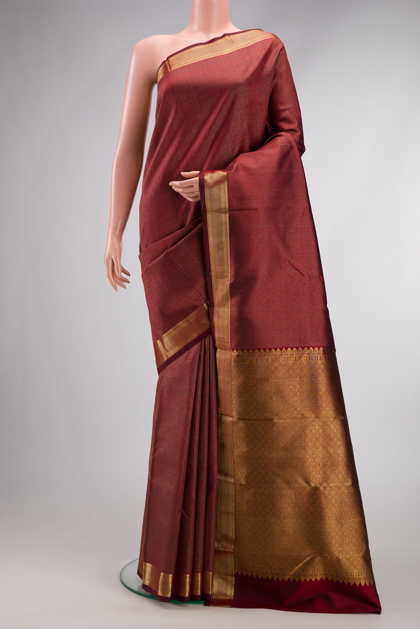 Maroon Dual Tone Kanchipuram Silk Saree with Stripes on the body and Zari Border.  displayed on a mannequin