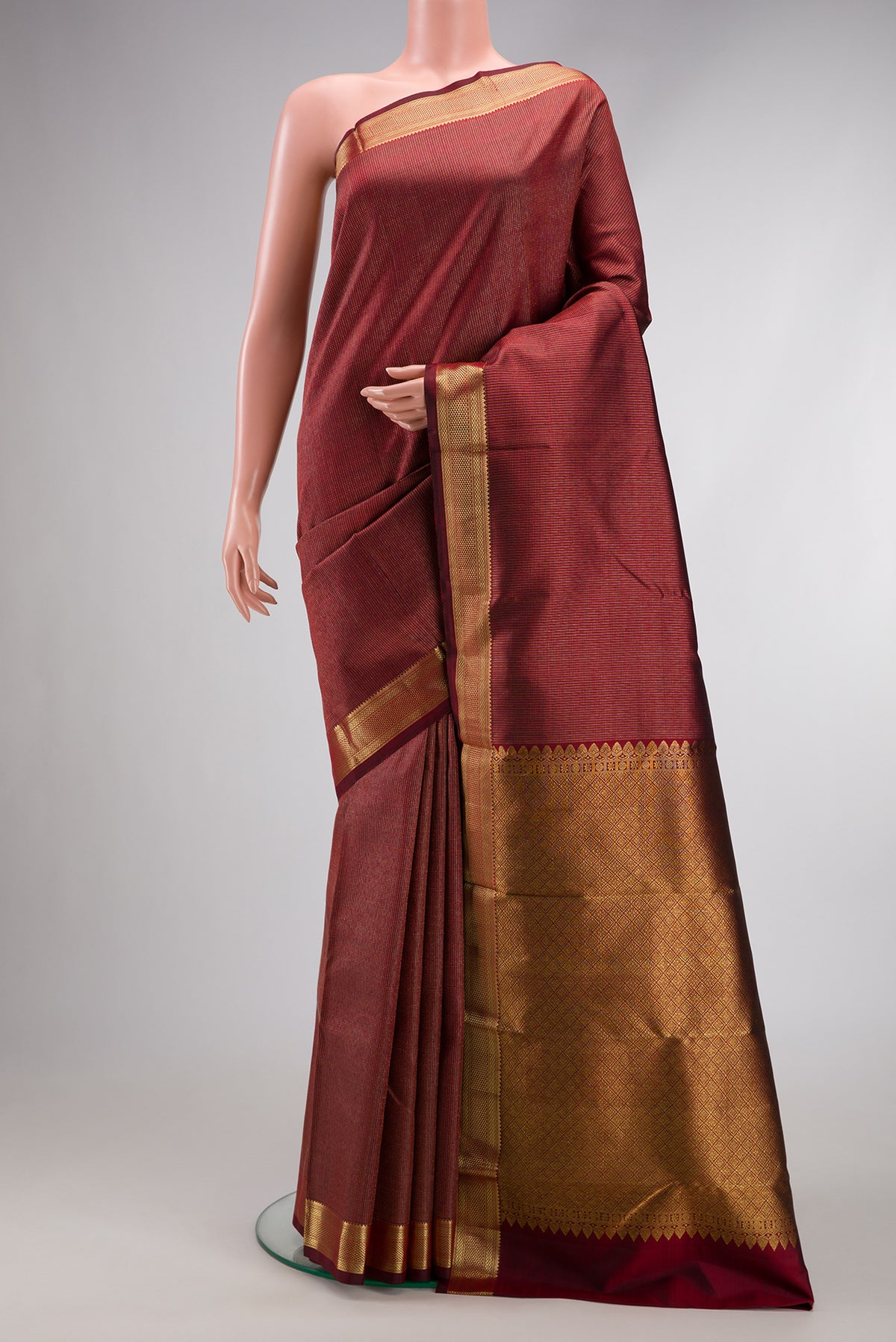 Maroon Dual Tone Kanchipuram Silk Saree with Stripes on the body and Zari Border.  displayed on a mannequin