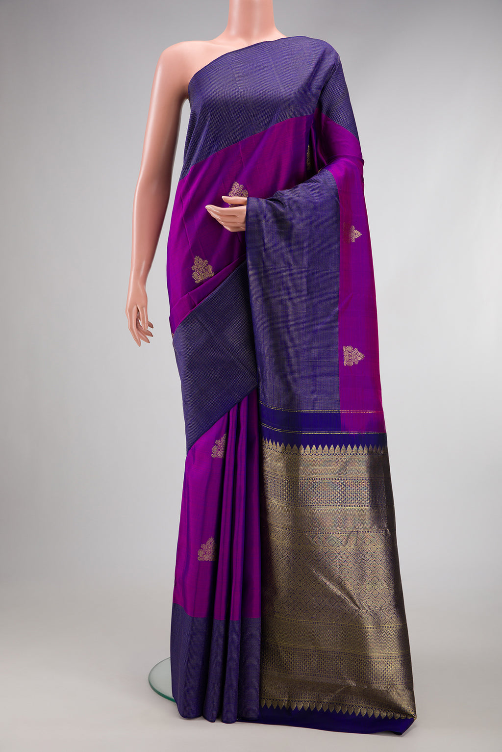 Purple Kanjivaram Silk Saree with Zari Butta on the body and Fancy Border.  displayed on a mannequin
