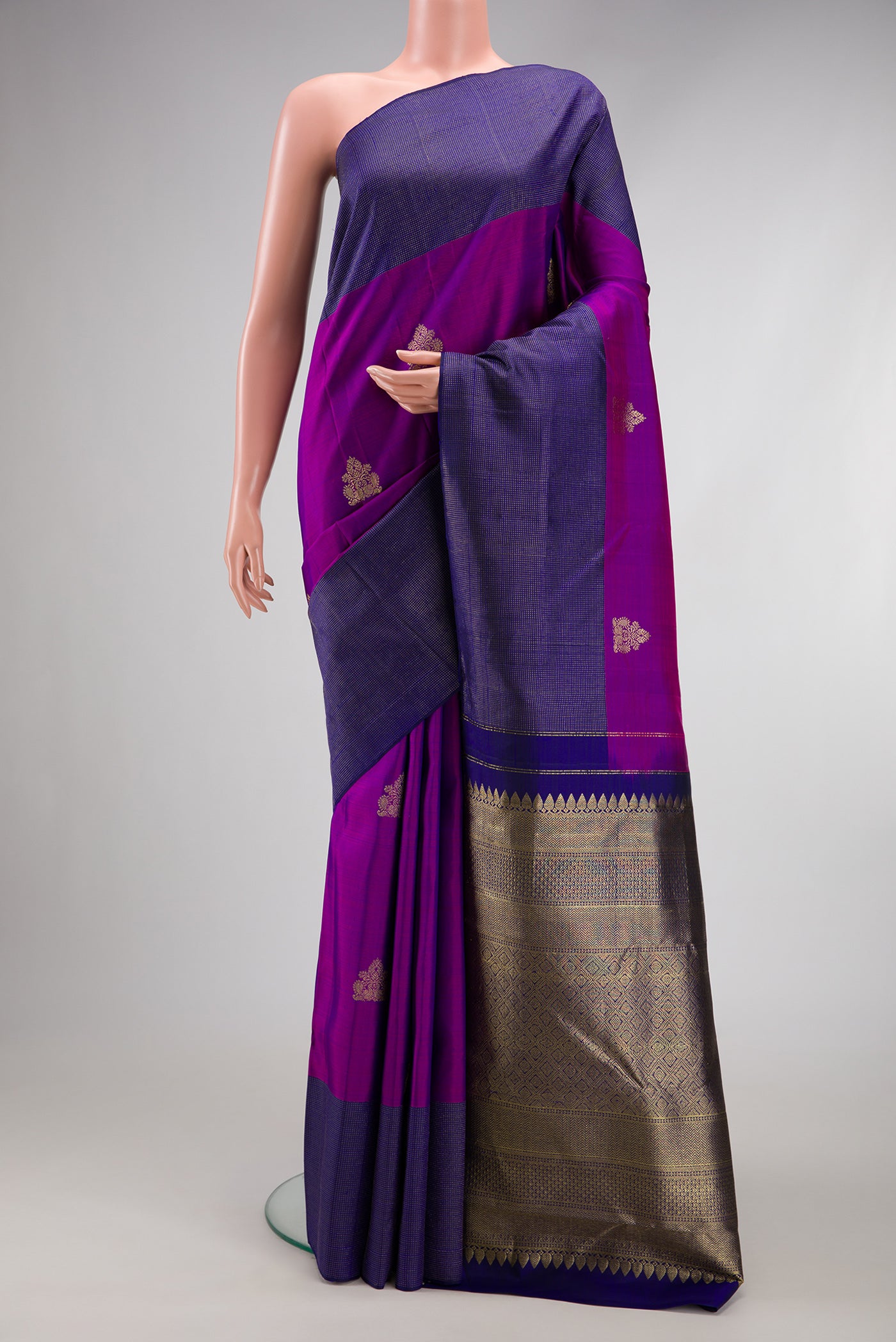 Purple Kanjivaram Silk Saree with Zari Butta on the body and Fancy Border.  displayed on a mannequin