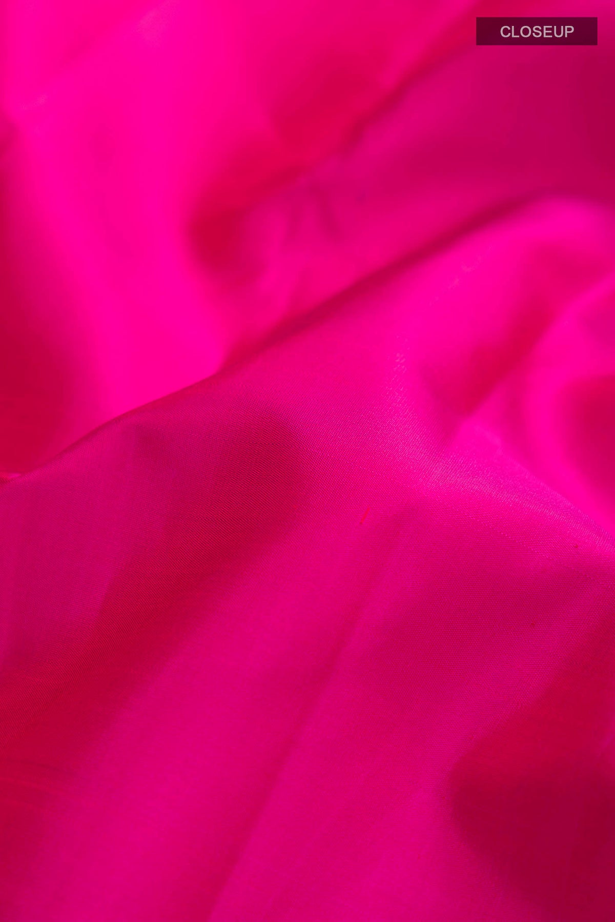 Close up of Pink Kanchipuram Silk Saree with Plain Body and Zari Border displaying folds