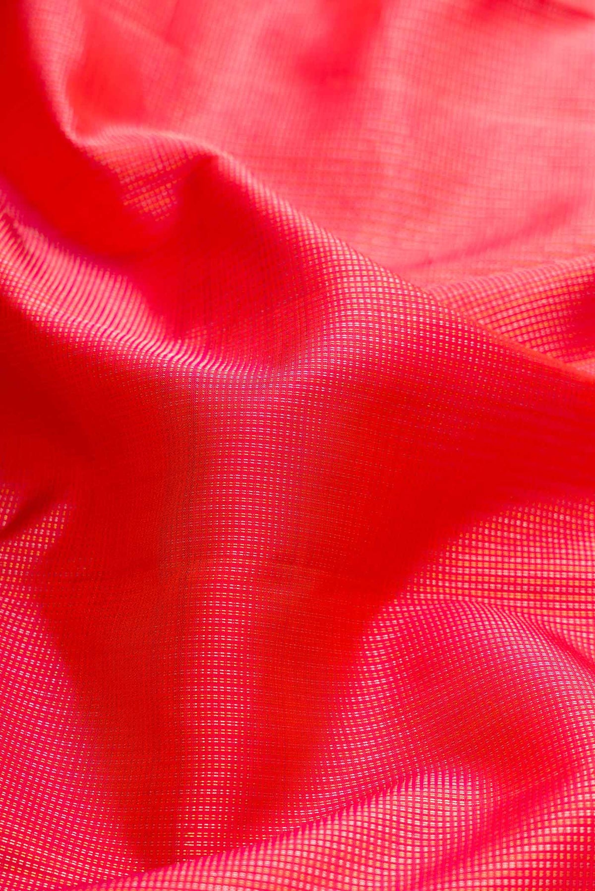Close up of Coral Dual Tone Kanchipuram Silk Saree with Zari Brocade on the body and Without Border displaying folds