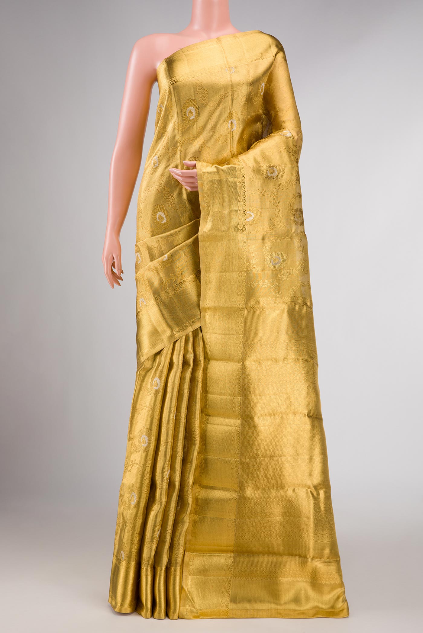 Pure Silk Pure Zari Gold Dual Tone Kanchipuram Tissue Saree with Zari Brocade on the body and Zari Border displayed on a mannequin