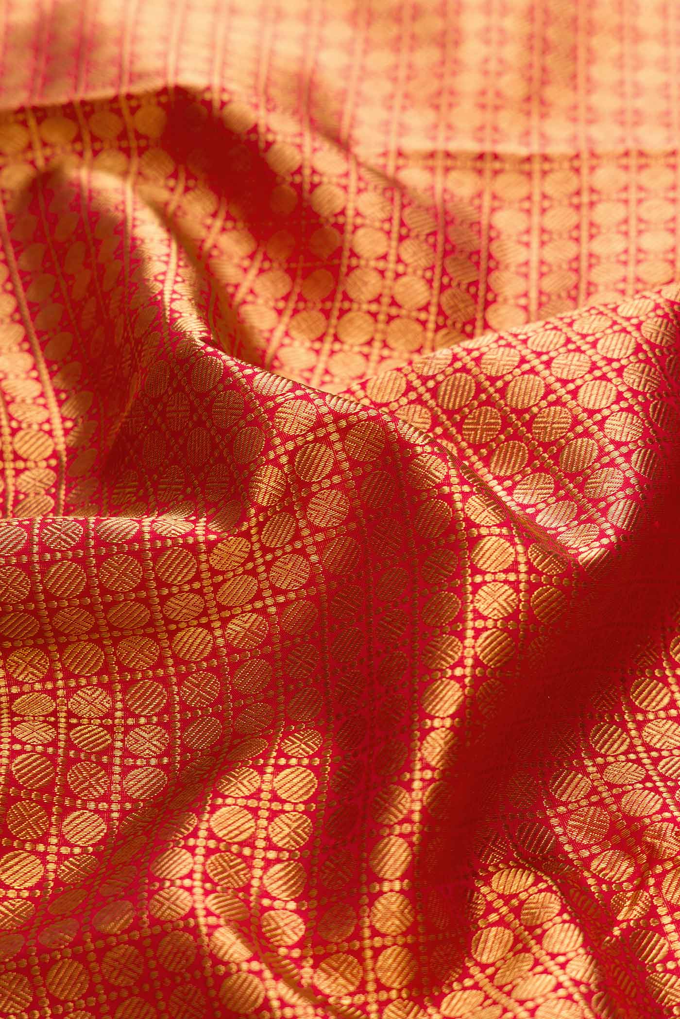 Close up of Red Dual Tone Kanchipuram Silk Saree with Zari Brocade on the body and Zari Border displaying folds