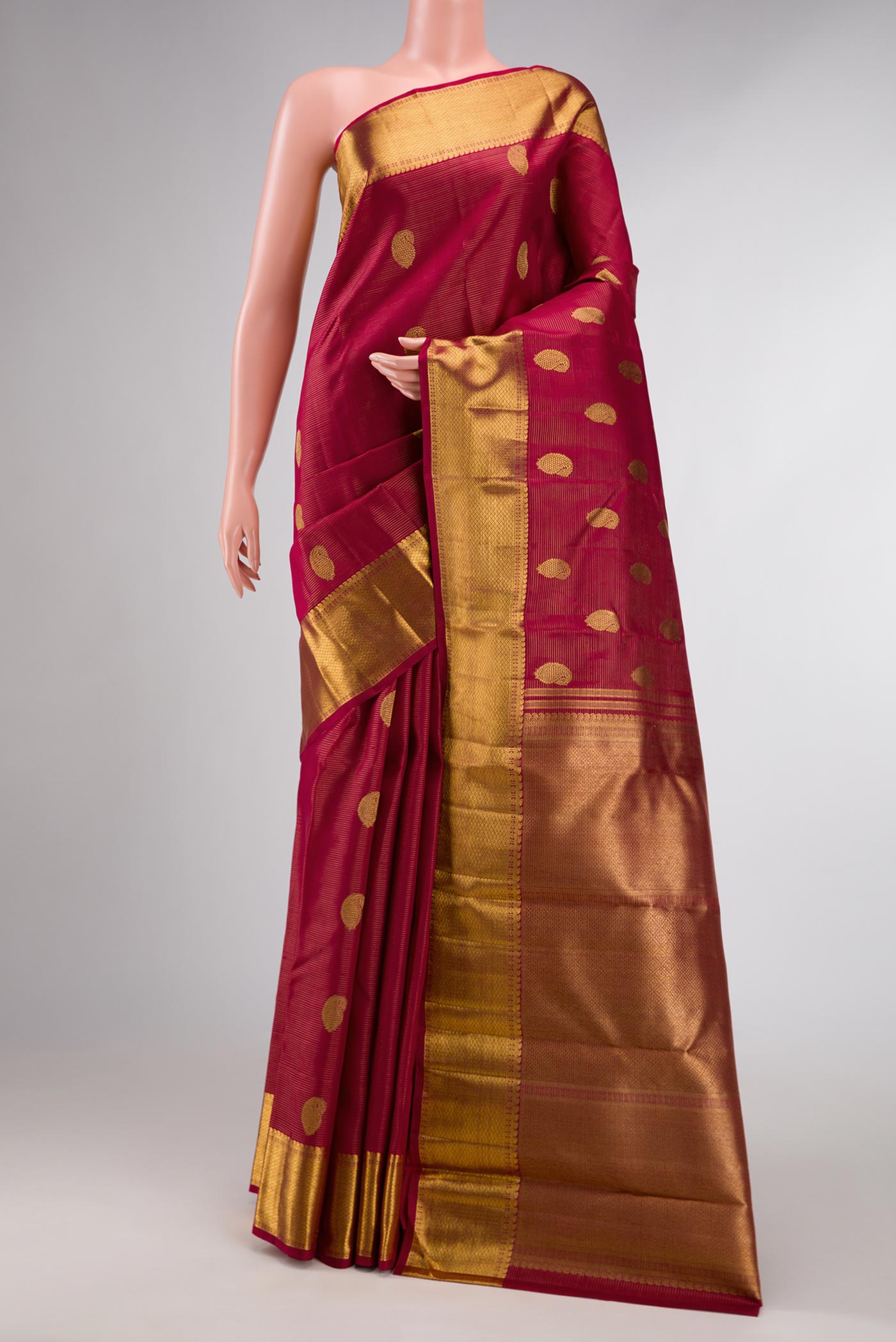 Pure Silk Pure Zari Red Dual Tone Kanchipuram Saree with Zari Butta on the body and Zari Border displayed on a mannequin