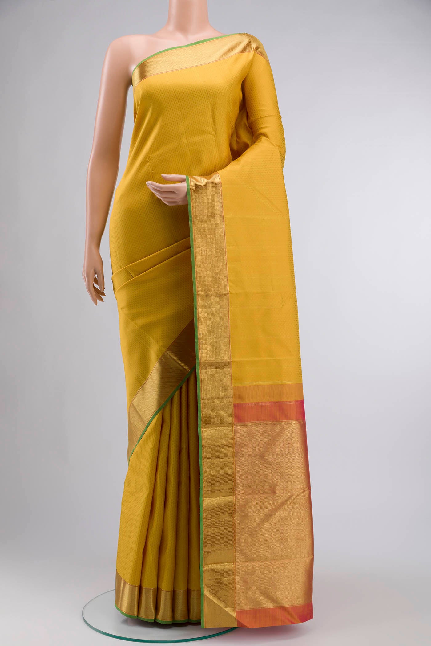 Yellow Kanchipuram Silk Saree with Jacquard design on the body and Zari Border displayed on a mannequin
