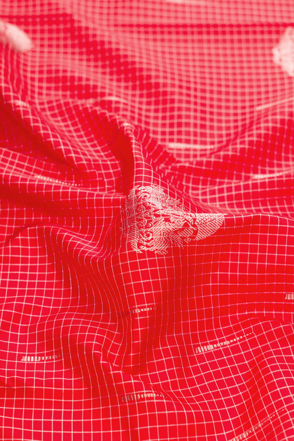 Close up of Pure Silk Pure Zari Red Dual Tone Kanjivaram Saree with Zari Butta on the body and Without Border.  displaying folds