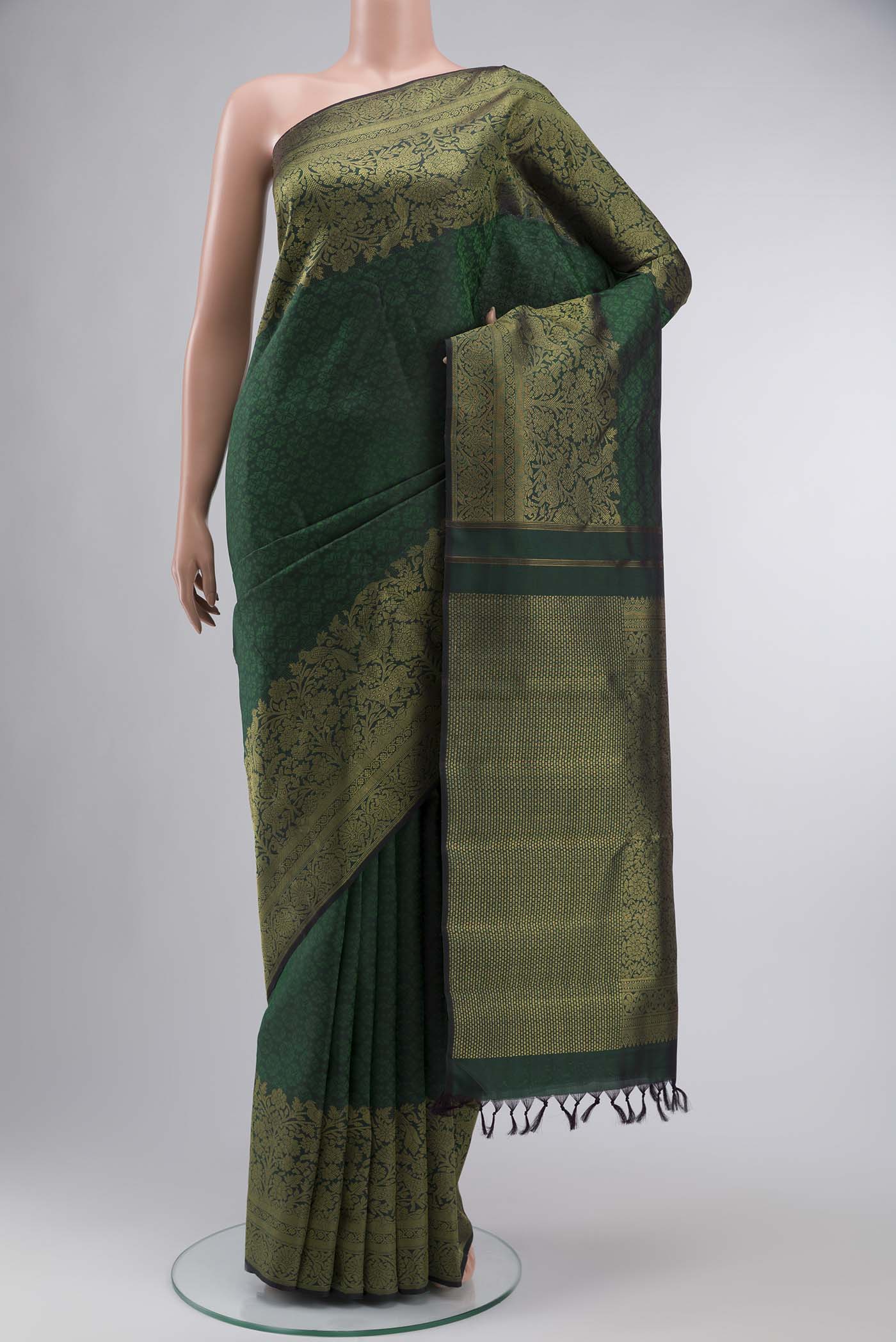 Green Kanchipuram Silk Saree with Jacquard design on the body and Zari Border displayed on a mannequin