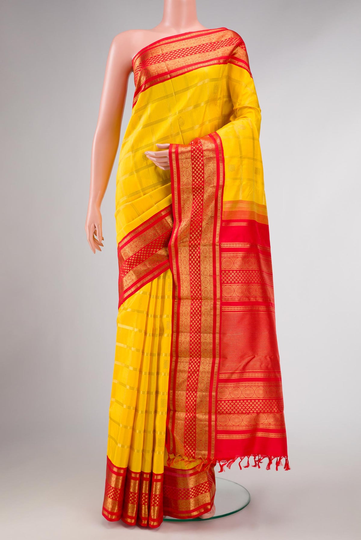 Pure Silk Pure Zari Yellow Dual Tone Kanchipuram Saree with Checked design on the body and Zari Border displayed on a mannequin