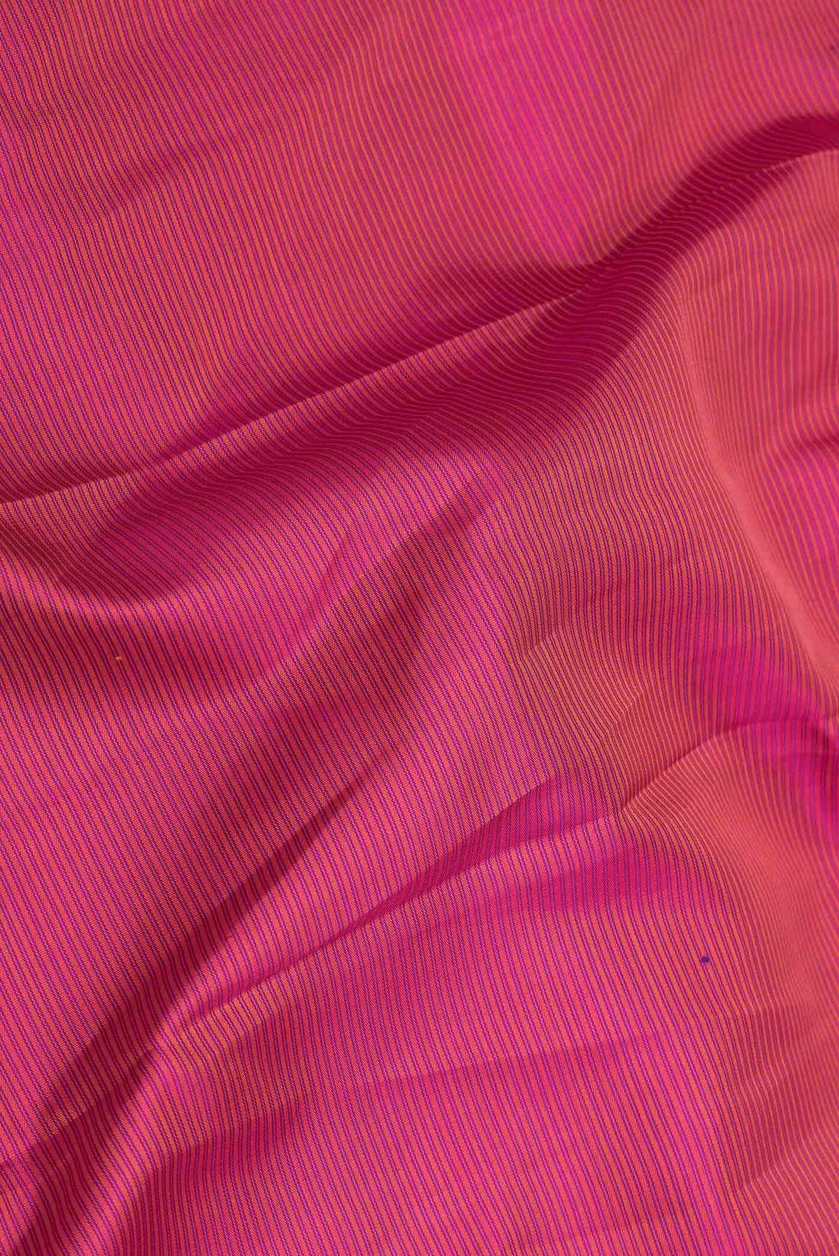 Close up of Pink Dual Tone Kanchipuram Saree with Stripes on the body and Zari Border displaying folds