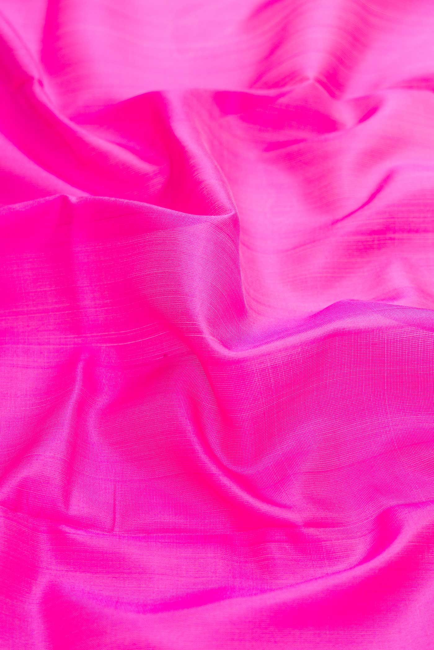 Close up of Pink Dual Tone Uppada Silk Saree with Plain Body and Zari Border displaying folds