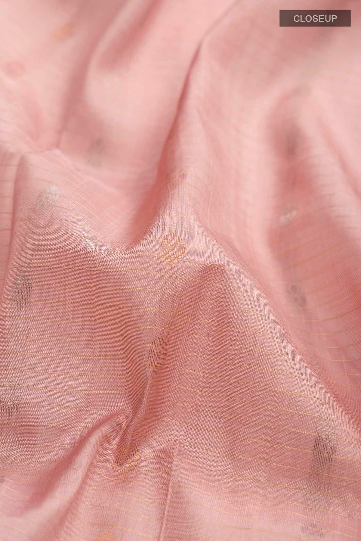 Close up of Pink Uppada Silk Saree with Zari Butta on the body and Zari Border displaying folds