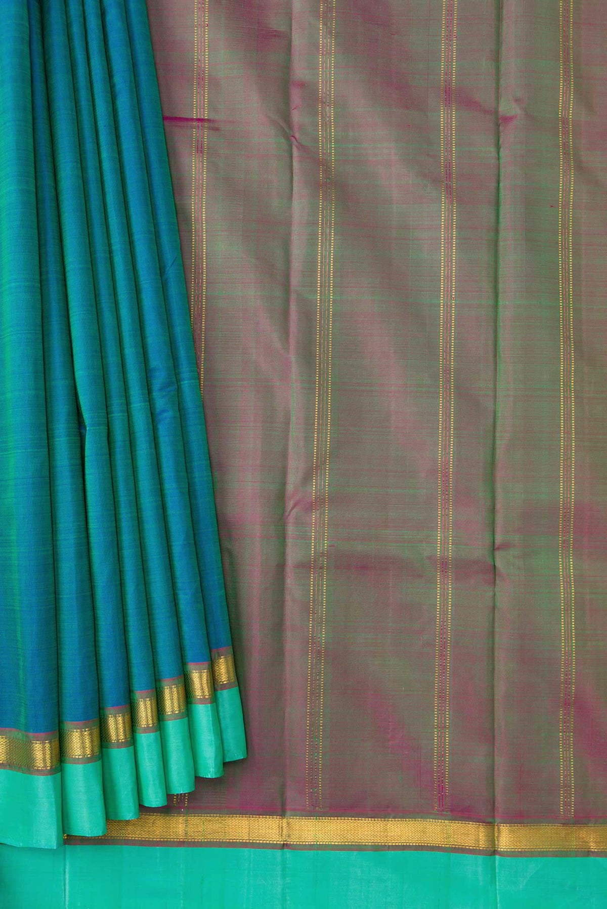 Pleats and pallu of Peacock Blue Dual Tone Kanchipuram Silk Saree with Plain Body and Zari Border