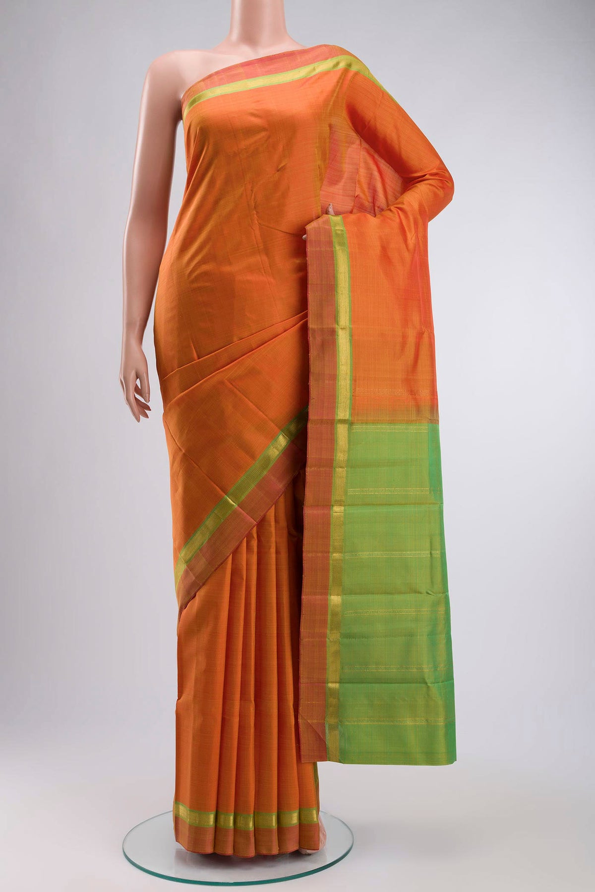 Orange Kanchipuram Silk Saree with Plain Body and Zari Border displayed on a mannequin