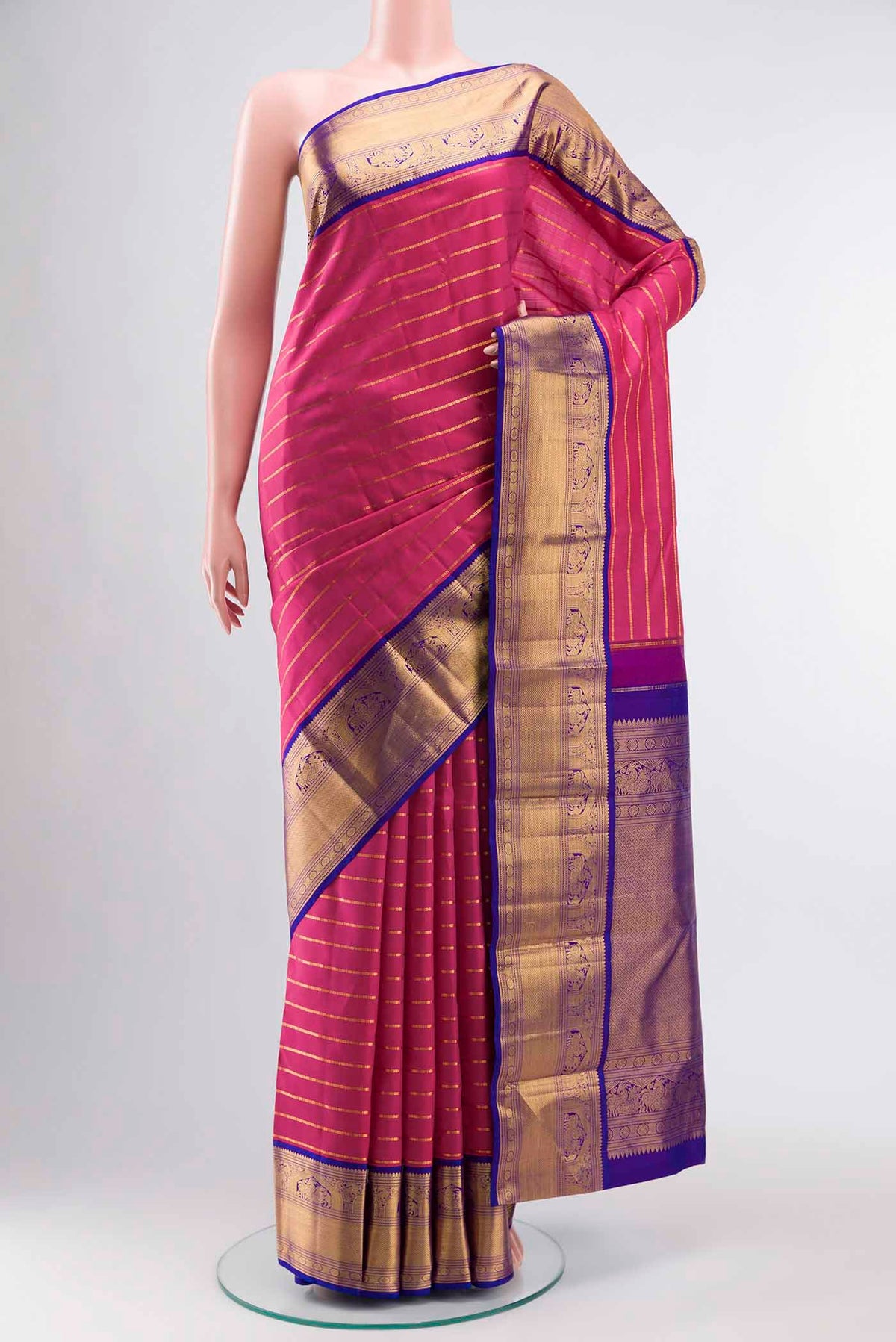 Pink Kanchipuram Silk Saree with Stripes on the body and Zari Border displayed on a mannequin