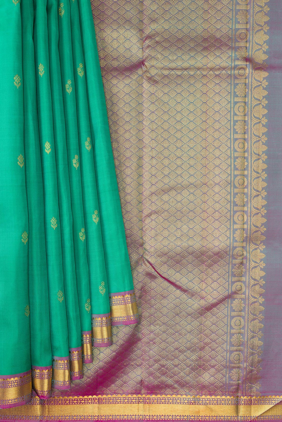 Pleats and pallu of Green Dual Tone Kanchipuram Silk Saree with Zari Butta on the body and Zari Border. 