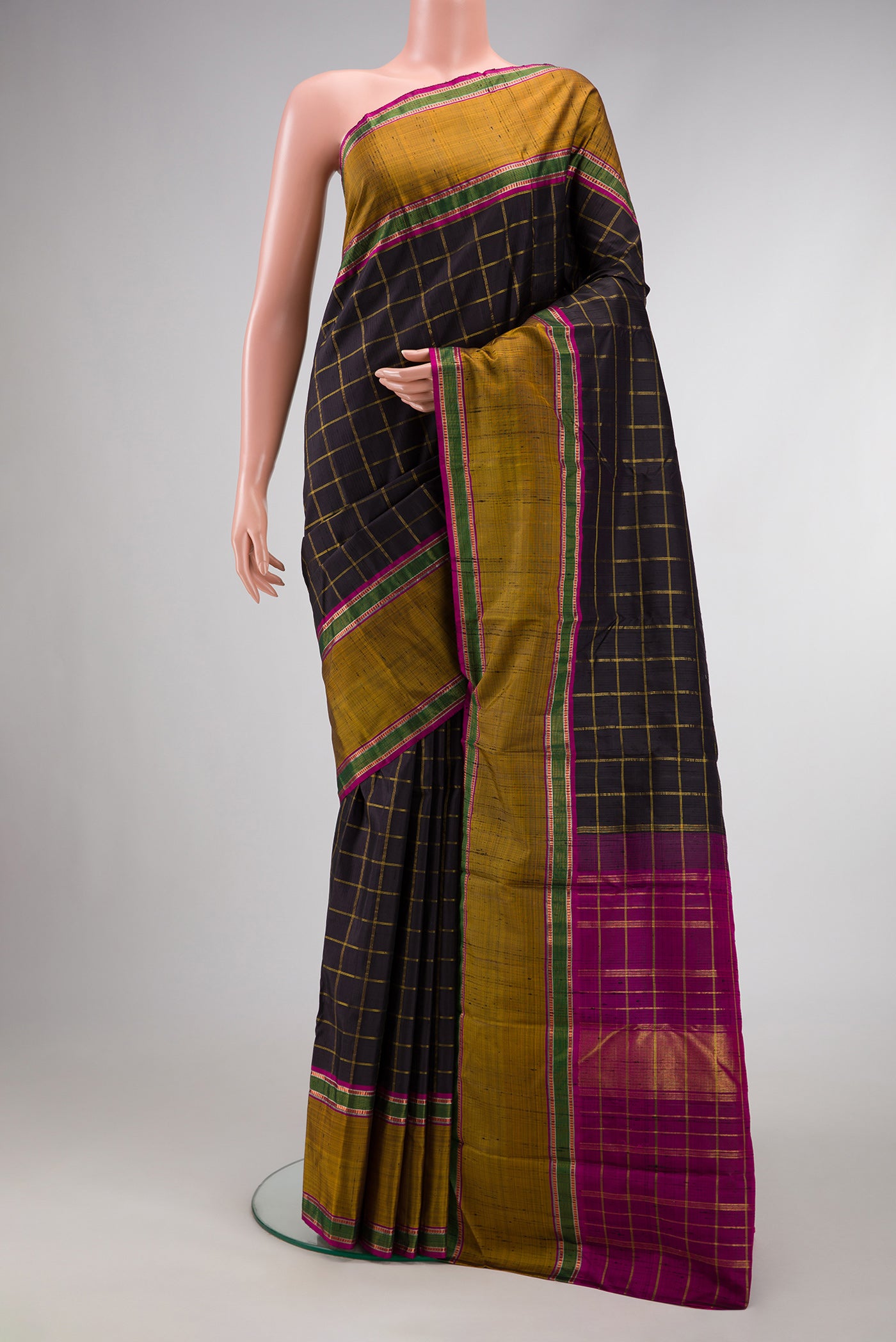 Black Dual Tone Kanchipuram Silk Saree with Checked design on the body and Zari Border.  displayed on a mannequin