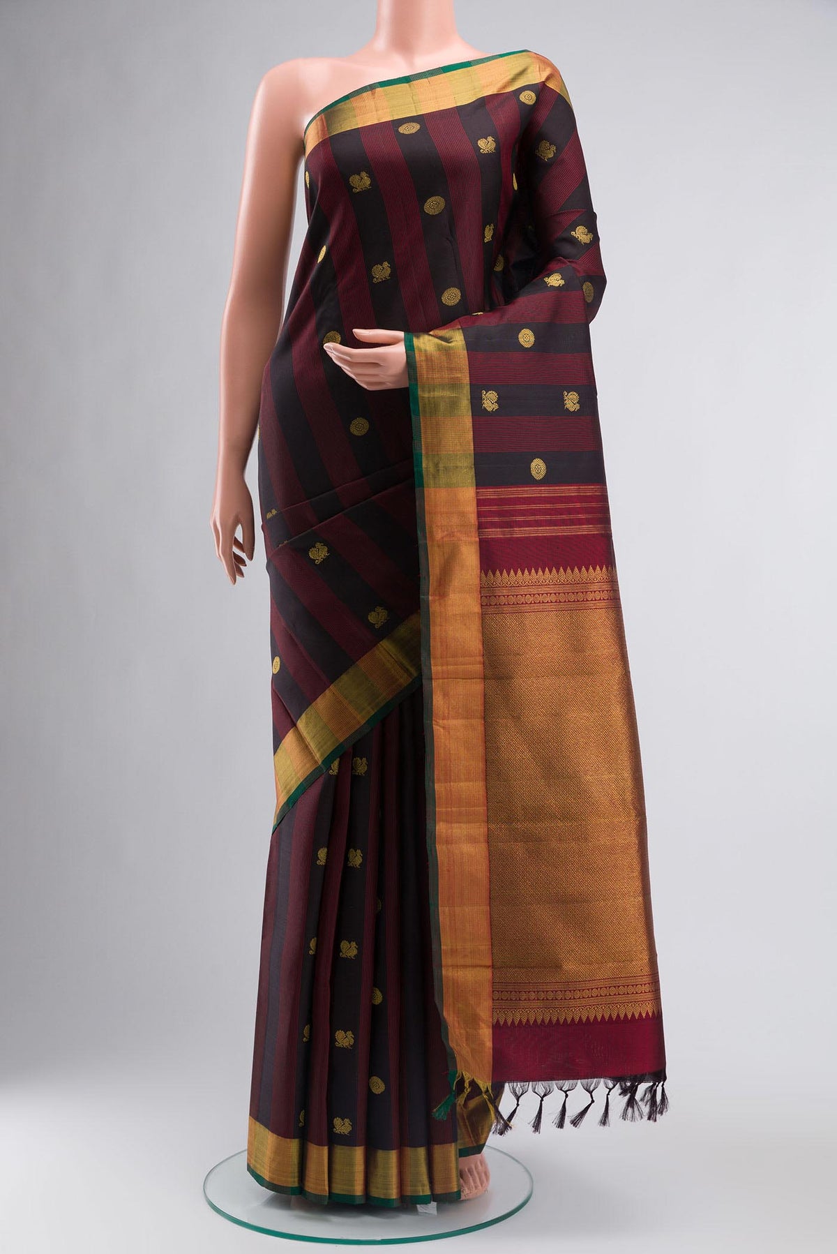 Black Kanchipuram Silk Saree with Zari Butta on the body and Zari Border displayed on a mannequin
