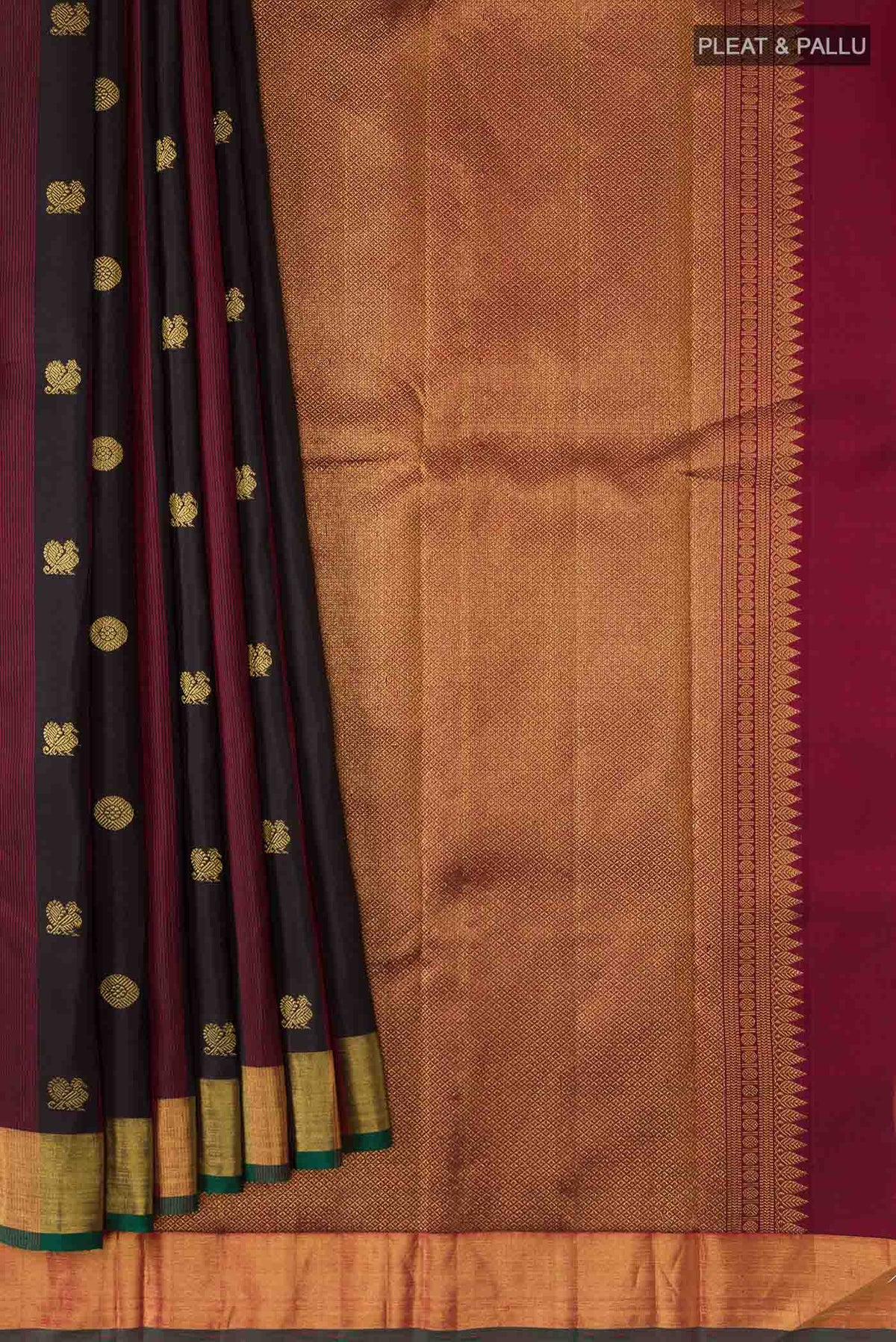 Pleats and pallu of Black Kanchipuram Silk Saree with Zari Butta on the body and Zari Border