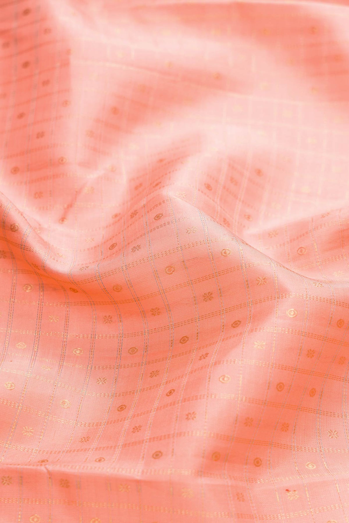 Close up of Pure Silk Pure Zari Peach Dual Tone Kanchipuram Saree with Checked design on the body and Zari Border displaying folds