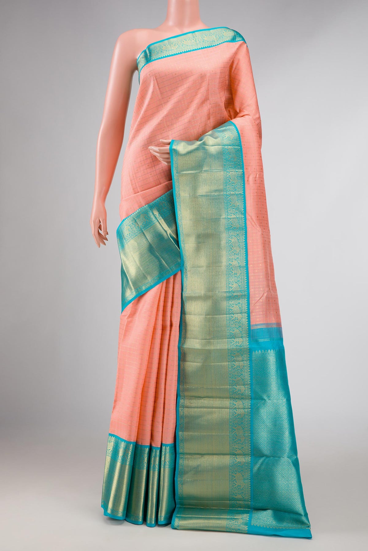 Pure Silk Pure Zari Peach Dual Tone Kanchipuram Saree with Checked design on the body and Zari Border displayed on a mannequin